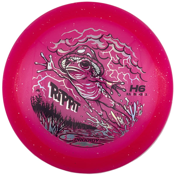 A bright pink Prodigy Rip Rat H6 disc golf disc with a detailed black and white fish graphic, displayed inside its white protective packaging box.