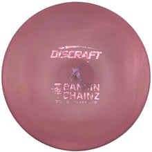 A pink Discraft Cannon Chainz disc golf disc resting on its white retail packaging, with the product name and model printed in white on the disc.