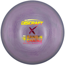A purple Discraft x Bangin' Chainz disc golf disc with yellow and red foil stamping, resting on a white surface.