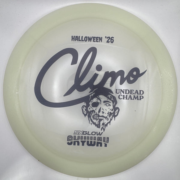 A translucent pale yellow-green disc golf disc with black printed graphics, including the name 'Climo' and 'Halloween '25', shown inside a white sleeve or box.