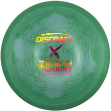 A green Discraft Bangin' Chainz disc golf driver disc with yellow and pink logo text, resting on a white surface.