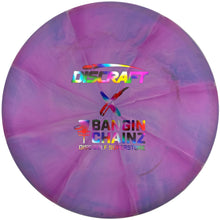 A Discraft x Bangin' Chainz Discraft Series 25 disc golf disc in purple and pink marbled plastic, shown inside its white packaging sleeve.