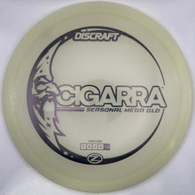 A Discraft Cicarra Personal Near-Flat disc golf disc in a translucent pale yellow/cream color, featuring black printed graphics and text, shown inside its white packaging sleeve.