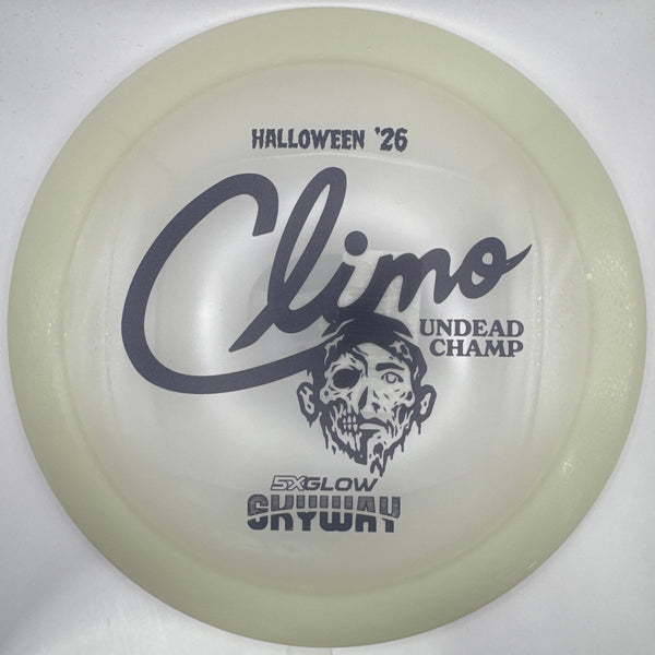 A translucent pale green disc golf disc with black printed graphics and text, including 'Halloween '26', 'Climo', and 'Undead Champ', resting on a white surface.
