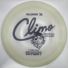A translucent pale green disc golf disc with black printed graphics and text, including 'Halloween '26', 'Climo', and 'Undead Champ', resting on a white surface.
