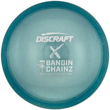 A Discraft x Bangin' Chainz Discraft Performance disc golf disc in a light blue color with a teal rim, shown inside its white packaging box.