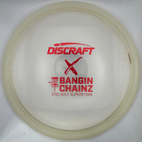 A translucent white Discraft Bangin' Chainz disc golf disc with red printed logos, displayed inside its white retail packaging.