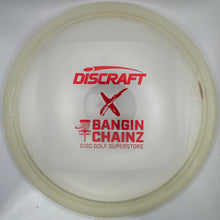 A translucent white Discraft Bangin' Chainz disc golf disc with red printed logos, displayed inside its white retail packaging.