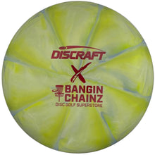 A Discraft x Bangin' Chainz disc golf disc in neon yellow-green, sealed in its original white plastic packaging with red printed logos.