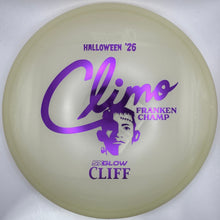 A translucent pale yellow disc golf disc with purple printed graphics, including the text 'Climb Franken Champ' and 'Halloween '26', resting on a white insert.