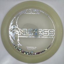 A Discraft Nukess Series 2024 Golf Club disc in translucent pale green, displayed inside its white protective packaging insert.