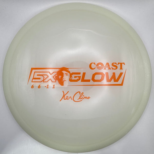A translucent off-white disc golf disc with orange printed graphics, including the text 'COAST GLOW' and 'Yee Zee', resting on a white foam insert.