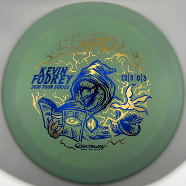 A green disc golf disc with a blue and gold Kevin Fodrey graphic, featuring lightning and a bird design, photographed against a neutral gray background.