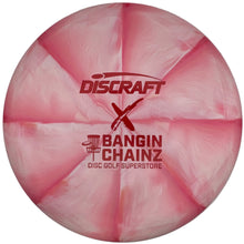 A pink marbled Discraft disc golf disc with red printed branding, shown inside a white circular display insert.