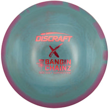 A Discraft X Bangin' Chainz disc golf disc with a light blue center and purple outer rim, featuring pink/red printed logos, shown resting on a white surface.