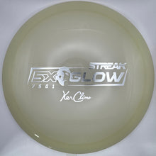 A translucent pale yellow disc golf disc, identified as an Excel Flow Streak in yellow, resting on a white insert with a purple surface visible on the right edge. The disc features the 'EXCEL' logo, 'STREAK' text, '250G1', and 'Xa Clime' signature.