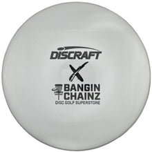 A white Discraft x Bangin' Chainz disc golf disc with black printed logos, shown inside its white protective packaging.