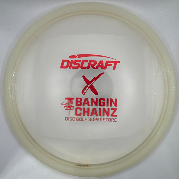 A translucent off-white Discraft disc golf disc with red printed text reading 'Discraft' and 'Bangin' Chainz Disc Golf Superstore' inside a white box.