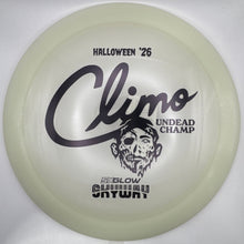 A translucent pale yellow-green disc golf disc with black printed graphics, including the text 'HALLOWEEN '26', 'Climo UNDEAD CHAMP', and '50GLOW', shown inside a white box.