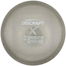 A Discraft Bangin' Chainz golf disc in a glittery champagne finish, resting on its white retail packaging card.