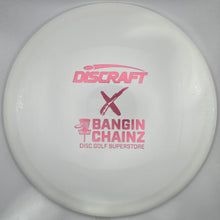 A white Discraft x Bangin' Chainz disc golf superstore disc with pink printed logos, shown inside its white packaging sleeve.