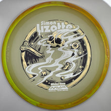 A translucent yellow-green disc golf disc with a metallic gold rim, featuring a graphic of a skull, bone, and smoke with the text 'Simon Lizotte' and 'MVP Official Team Series'.