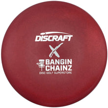 A close-up of a disc golf disc in a deep red color, featuring white printed logos for Discraft and Bangin' Chainz.