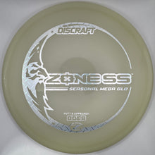 A Discraft Z-NESS Seasonal Mega Glo disc golf disc in a translucent pale green color, resting inside its white packaging box.