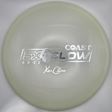 A translucent pale green disc golf disc with silver foil stamping of the text 'COAST EXO GLOW' and 'Yo-Clime', displayed inside its white outer packaging.