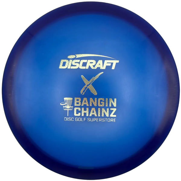 A blue Discraft Bangin' Chainz disc golf disc with gold foil lettering, resting on a white surface.