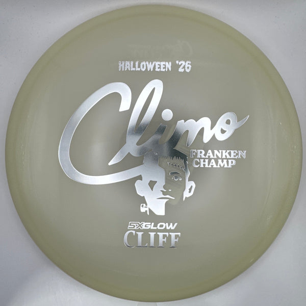 A translucent pale yellow-green disc golf disc with silver foil stamping, shown inside its white presentation box. The stamping features the text 'Climax', 'Halloween '26', 'Strancken Champ', and 'Sixlow Cliff'.