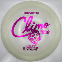 A translucent off-white disc golf disc with hot pink printed graphics, including the text 'HALLOWEEN '26', 'Climo UNDEAD CHAMP', and '50GLOW SKYWALK'.
