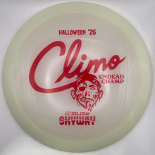 A translucent off-white disc golf disc with red printed graphics, including the text 'HALLOWEEN '26', 'Climo', 'UNDead Champ', and 'EXGLOW SHAYWY'. The disc is photographed inside its white retail packaging.