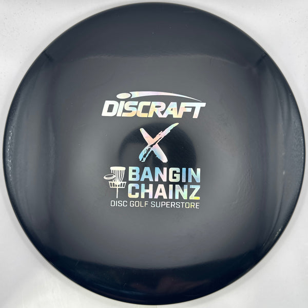 A close-up of a Discraft x Bangin' Chainz disc golf disc, showing the black outer barrel with white and multicolor logos, set against a white and purple background.