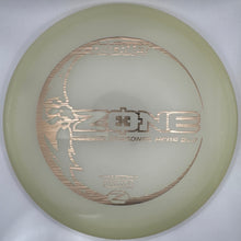 A translucent pale yellow-green disc golf disc with metallic rose gold foil stamping, shown inside its white protective packaging insert.