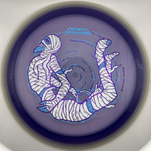 A disc golf disc with a purple base, featuring a white and blue illustrated design of a curled-up figure, photographed inside a white circular holder.